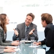 Happy team laughing together at a meeting