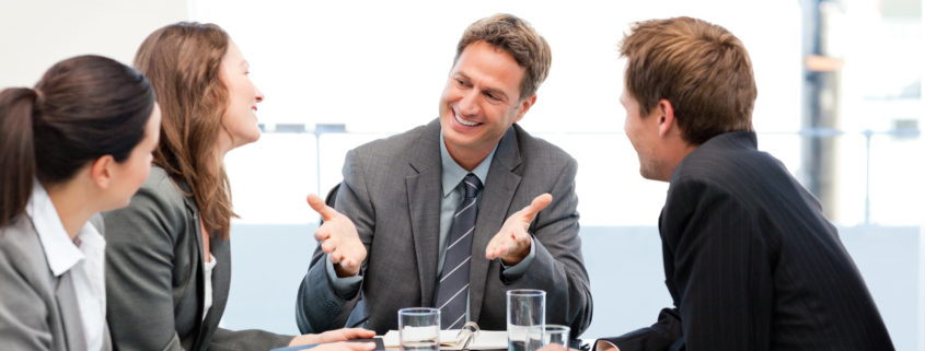 Happy team laughing together at a meeting