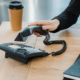 Woman sitting at a desk putting the desk phone down after a call