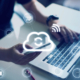 Employees using a laptop and smartphone connected through cloud communication tools