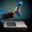 Hand holding a telephone receiver emerging from a laptop screen
