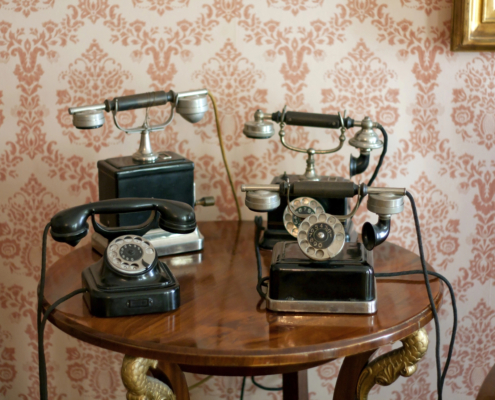 Collection of antique telephones showing the history of business communication