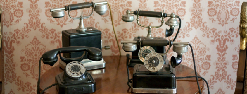 Collection of antique telephones showing the history of business communication