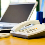 Business leader evaluating outdated phone system modernization options for growing company