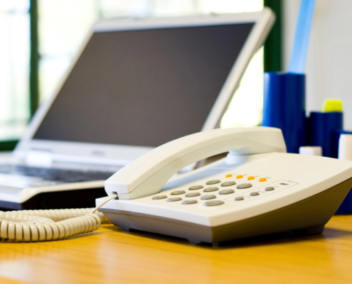 Business leader evaluating outdated phone system modernization options for growing company