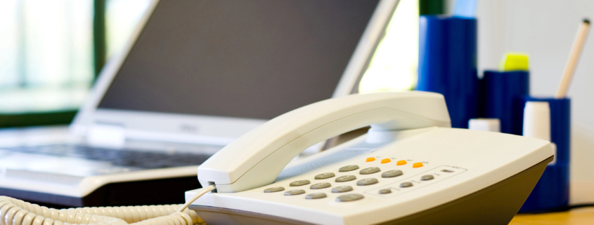 Business leader evaluating outdated phone system modernization options for growing company